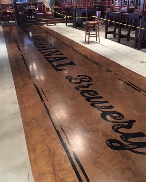 epoxy floor coatings with logo and graphics applied in food and beverage facility