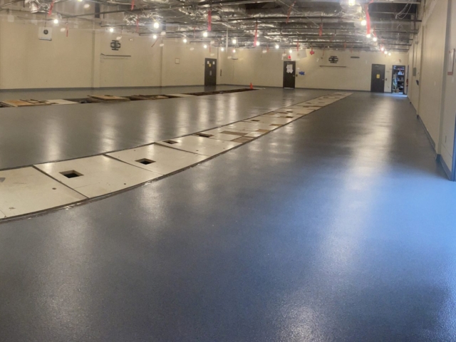Industrial Applications, Inc. installed Decorative Quartz epoxy floor coatings for manufacturing facility in a large room.