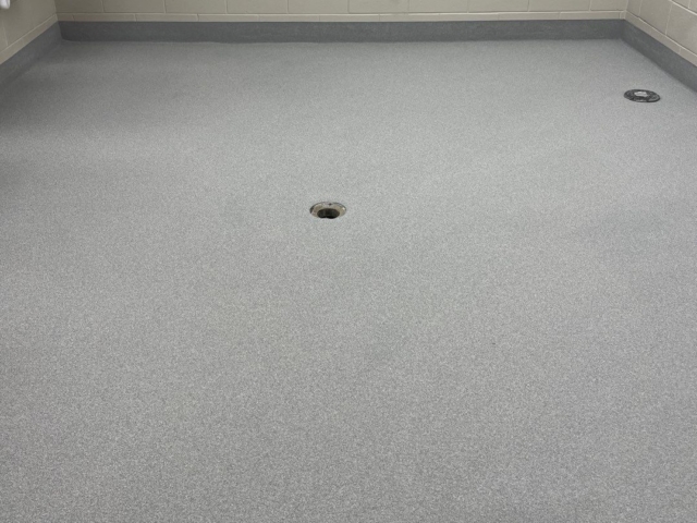 Industrial Applications, Inc. installed a two mid coat with colored quartz aggregate to a school bathroom flooring.