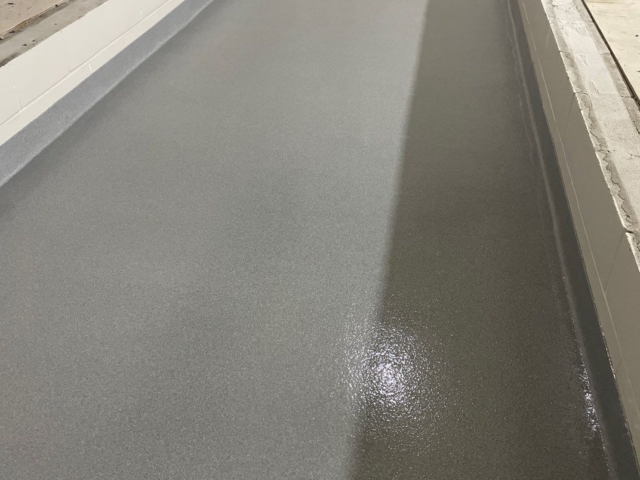 Post construction photo of the installation done by Industrial Applications, Inc. decorative quartz flooring for school, a slip-resistant flooring throughout the school