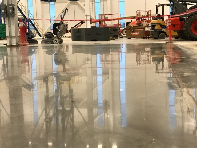 large equipment used to polish concrete for an airplane hanger