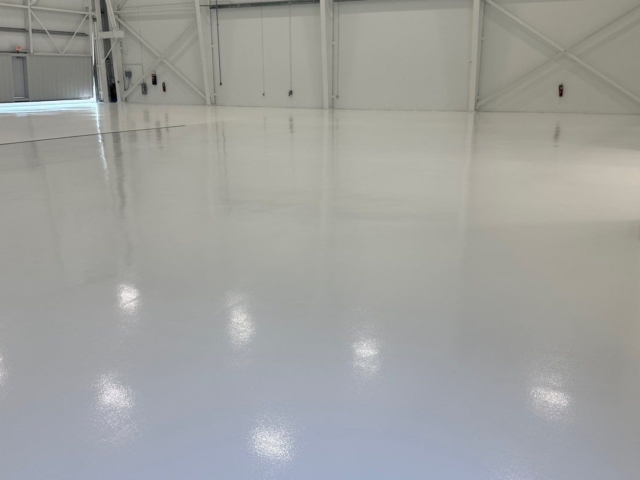 airplane hangar with a durable and stunning epoxy and urethane coated floor!