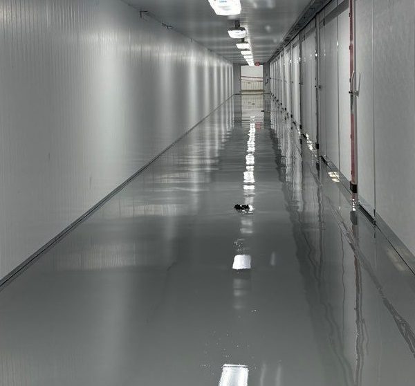 At food production company, IA installed moisture mitigating primer, epoxy and urethane topcoat with slip resistant additive for safety to the hallway.