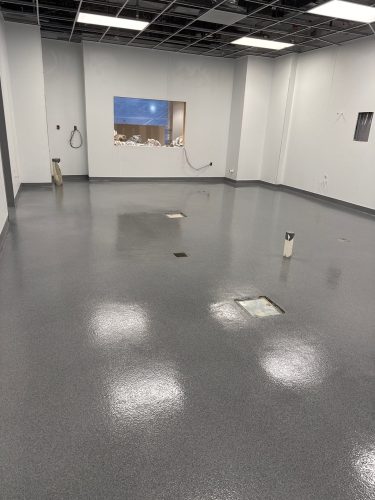 Industrial Applications, Inc. installed a seamless decorative quartz epoxy floor with a polyaspartic topcoat in the commercial kitchen.