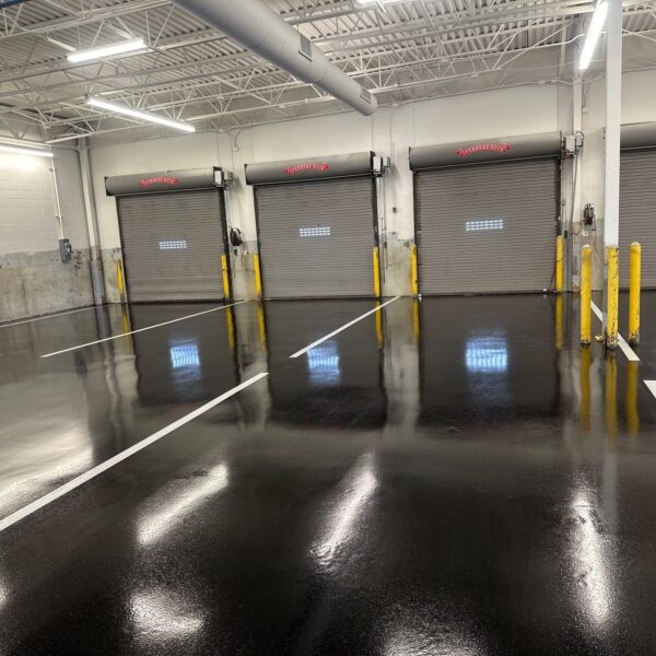 Industrial Applications, Inc. prepped floors and applied epoxy coat to dock doors floor area in service shop.