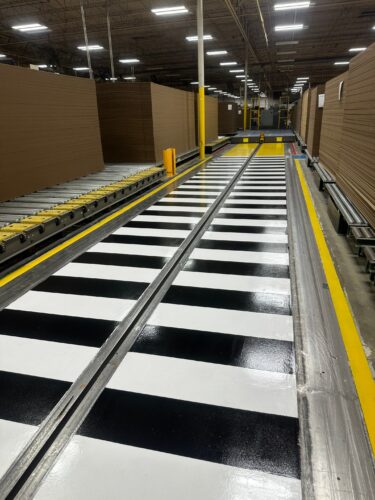 Clear Aisles. Safer Floors. Smoother Operations. Epoxy aisle markings and line striping aren’t just about appearance, they're about safety, efficiency, and control. When a leading American paper and packaging company needed to improve their facility’s traffic flow and visibility, they trusted Industrial Applications Inc. to deliver. We installed high-performance epoxy aisle markings, safety line striping, and polished concrete floors to help create a clean, organized, and OSHA-conscious environment. These 6S-compliant floor systems clearly define pedestrian walkways, equipment zones, and hazard areas, reducing accidents, confusion, and downtime.