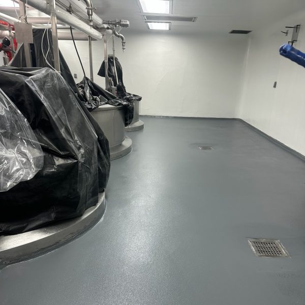 A leading medical-device manufacturer trusted Industrial Applications to stop costly leaks caused by thermal-shock wash-downs in their multi-storyplant. In just 48 hours, TeamIA mobilized multiple crews, profile-ground the worn overlayment, repaired the underlying concrete, and re-textured critical zones. We then installed a high-performance 2-coat epoxy + urethane system in heavy-traffic corridors and a cementitious urethane mortar where extreme chemical and temperature cycling demanded extra muscle.