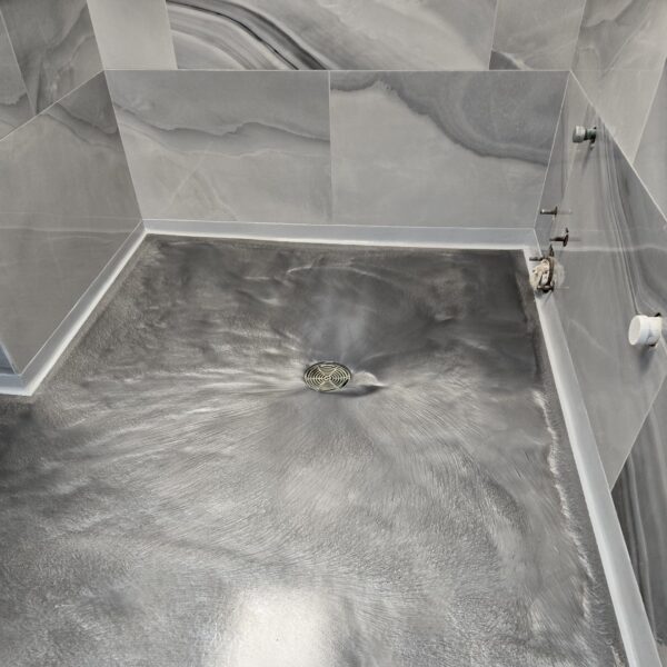Industrial Applications Inc demoed tile and removed adhesives before prepping the concrete for epoxy coatings.  TeamIA installed thin mil epoxy coatings in the hallways, offices and conference rooms and a fantastic looking metallic epoxy coating in the lobby and restrooms with coloring chosen to complement their wall coverings and preferred décor. 