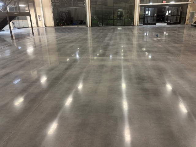 Our team demoed nearly 9,000 square feet of deteriorated coating, then made structural and cosmetic repairs before dyeing and polishing the concrete to a medium-high gloss finish.&nbsp;
