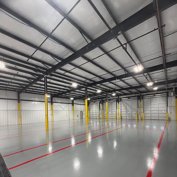 Two coat epoxy flooring system with a broadcast aggregate for slip resistance across nearly 17,000 square feet of shop and tool room space.
