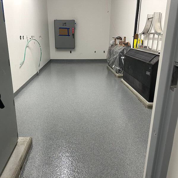 Industrial Applications mobilized highly trained crews to prepare over 6,000 square feet of new concrete to achieve the proper surface profile. We then installed a Tnemec epoxy mortar with decorative flake system, along with thousands of linear feet of 4 inch integral cove base.