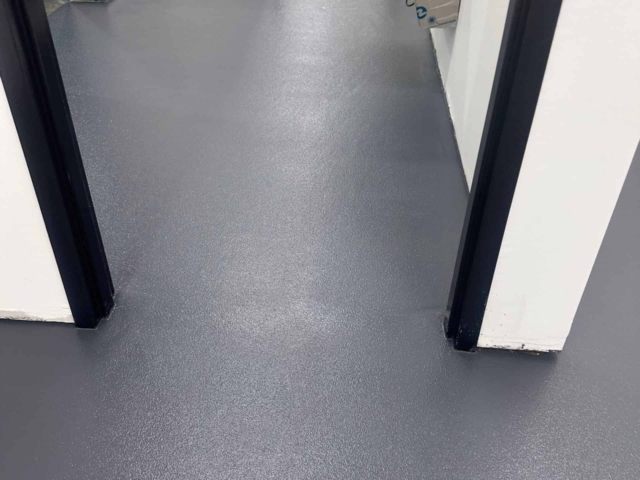 IA installed nearly 5,000 square feet of urethane concrete flooring with an epoxy grout coat and HTS topcoat throughout this industrial manufacturing facility's breakroom and locker rooms