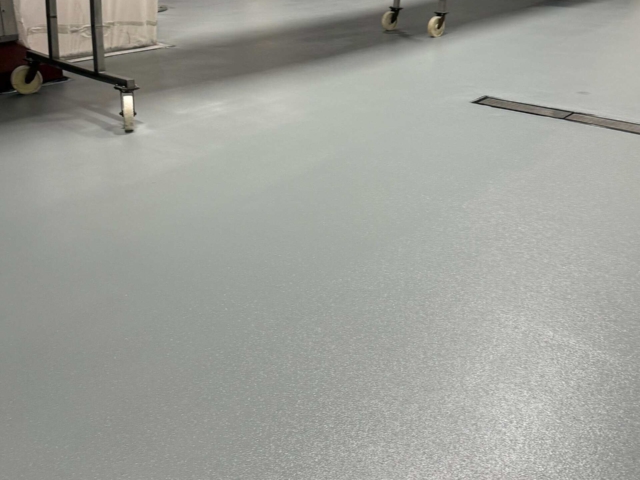 Our crews removed damaged flooring, rebuilt the area using high-performance urethane concrete, and installed crowned and properly pitched surfaces to direct water efficiently to the new drainage system.