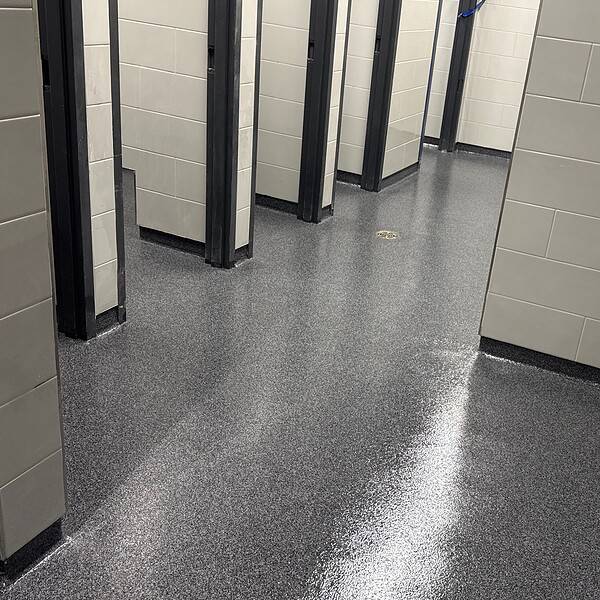 More than 12,000 square feet in a high school. Multiple environments. One high-performance troweled quartz flooring solution.
