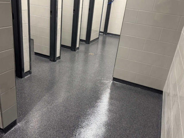 More than 12,000 square feet in a high school. Multiple environments. One high-performance troweled quartz flooring solution.