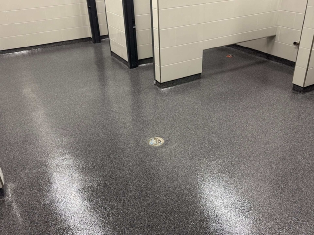 Industrial Applications, Inc. installed a technically demanding troweled quartz flooring system throughout the hallways, restrooms, and commercial kitchen of a busy high school.